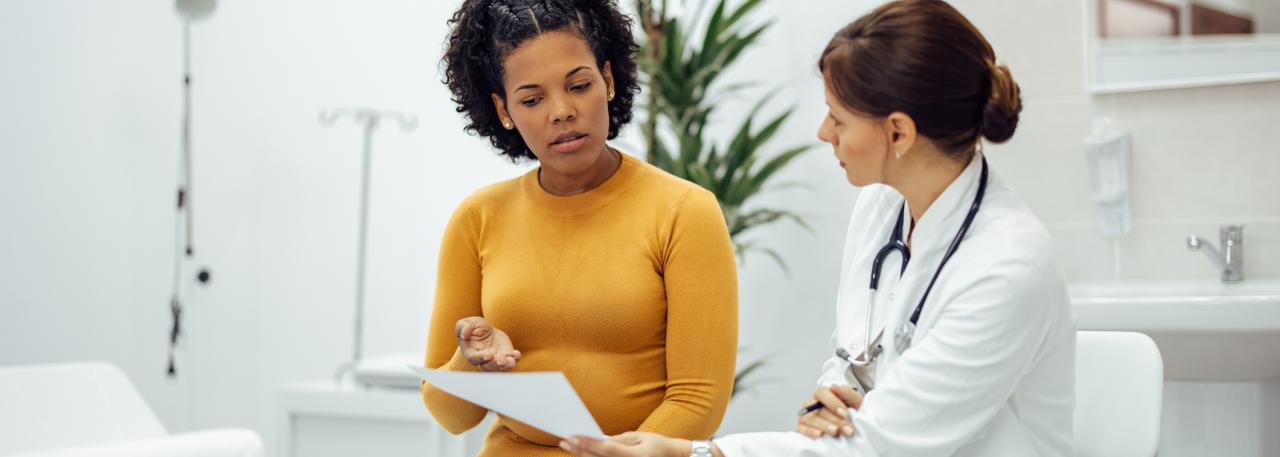 doctor shows patient test results on paper