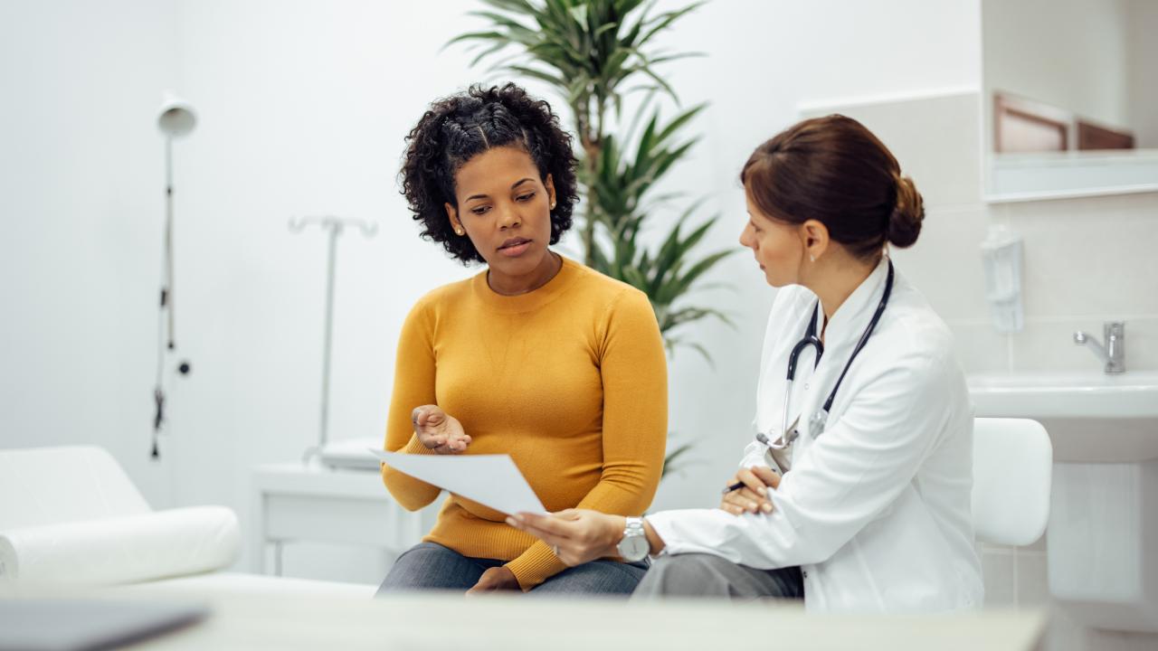 doctor shows patient test results on paper